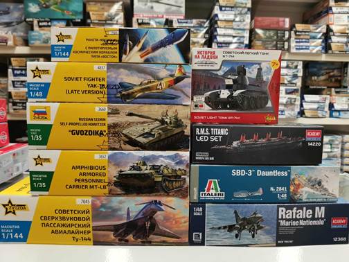 A stack of boxes with pictures of tanks and planes
AI-generated content may be incorrect.